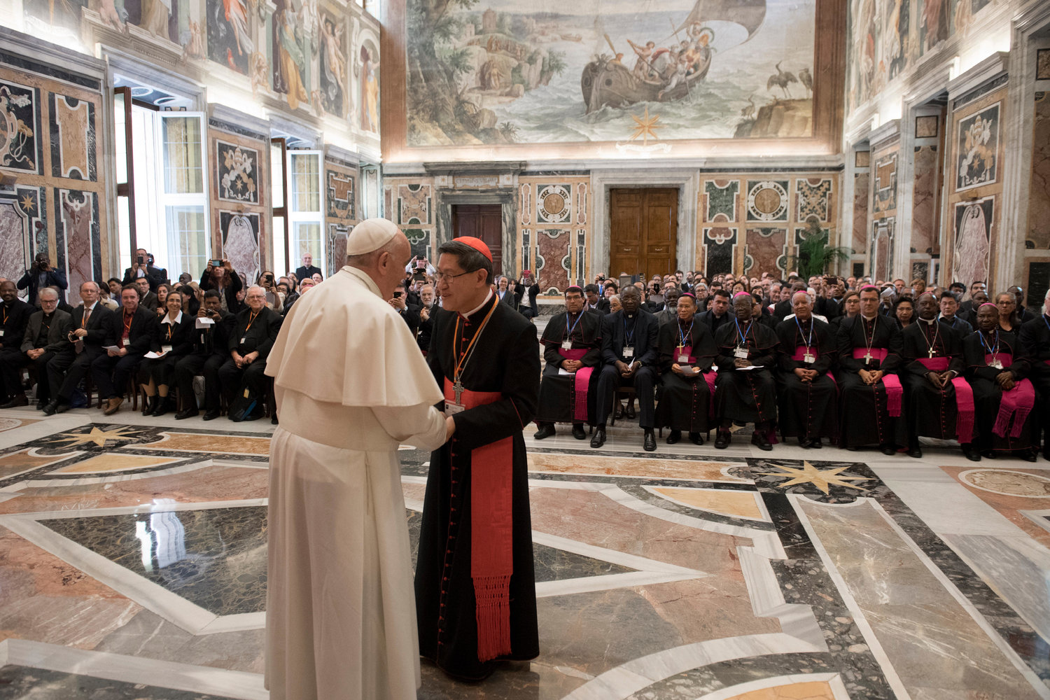 Philippine Cardinal Luis Antonio Tagle of Manila, president of the Catholic Biblical Federation, greets Pope Francis April 26, 2019, at the Vatican during a special audience marking the federation’s 50th anniversary.